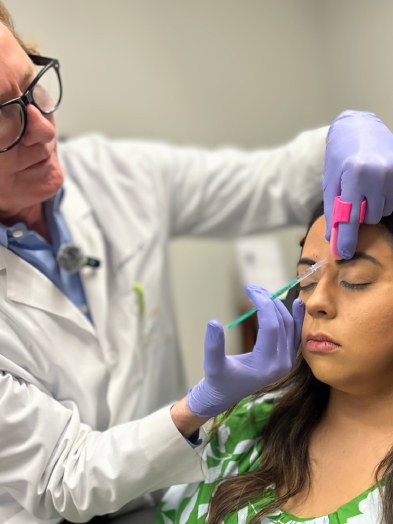 Dr. Stewart injecting Botox into a woman's forehead